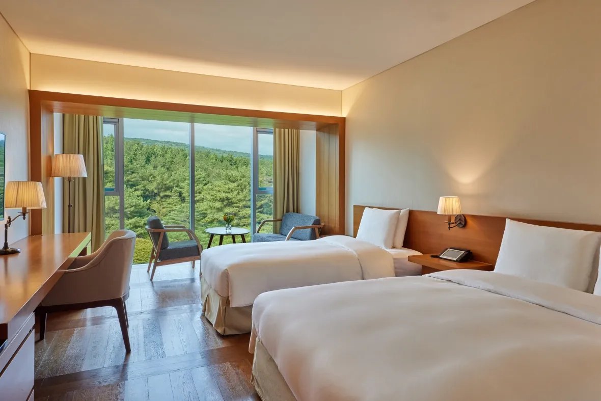 A twin room at WE Hotel looking onto the forest