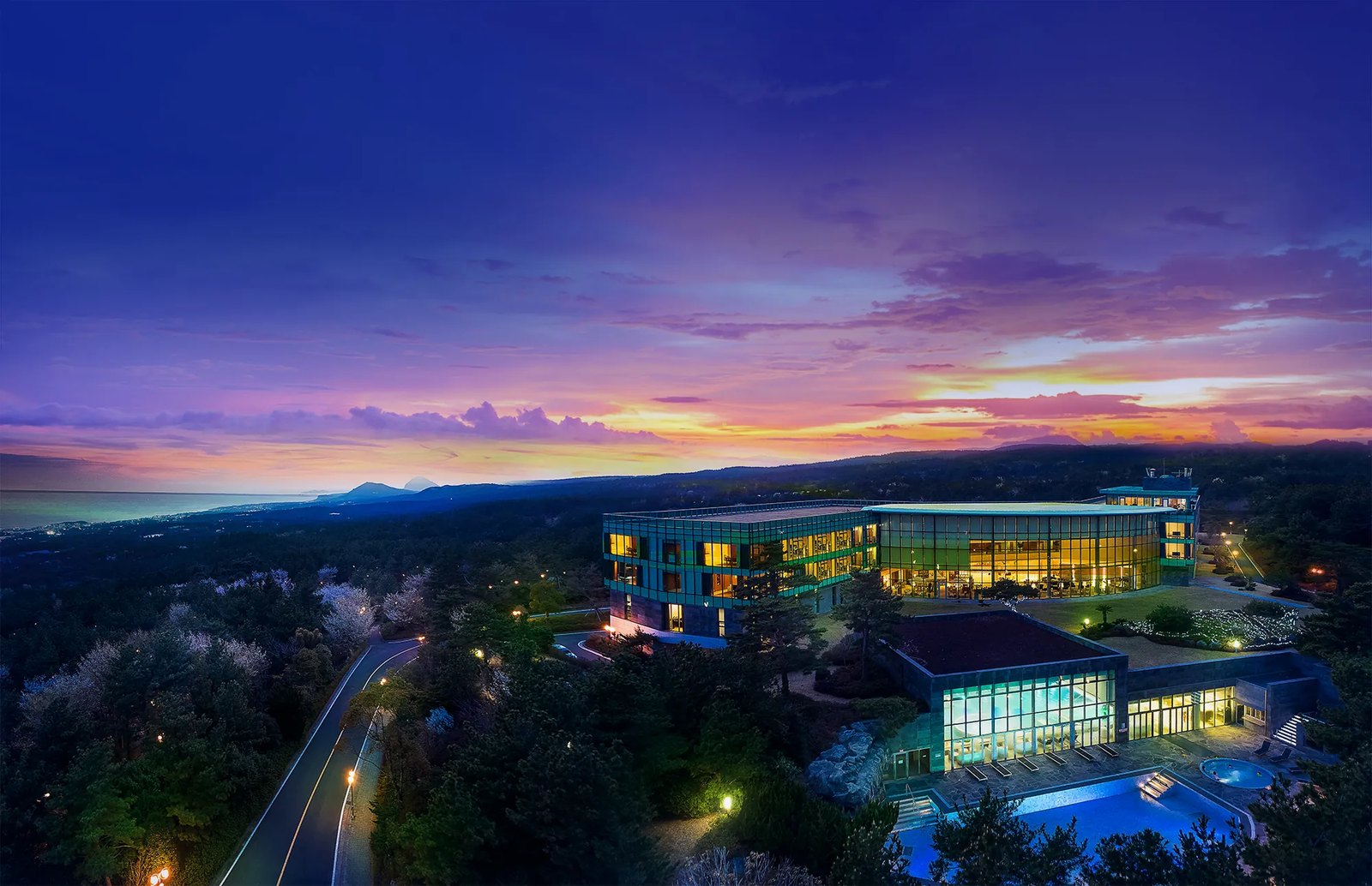 WE Hotel at dusk, set in the forest